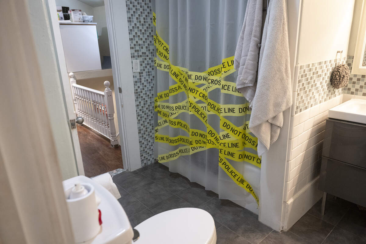 A crime scene tape shower curtain hangs in the bathroom at the former home of serial killer Dorothea Puente, now known as The Innocent House, during Preservation Sacramento’s annual historic home tour in Sacramento on Sunday. Puente, who operated the home as a boarding house, murdered nine of the home’s lodgers and buried them in the yard in the 1980s.